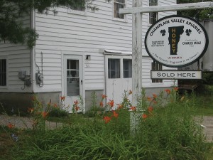 Champlain Valley Apiaries honey house and shop. The image on the sign of the state of Vermont and clover leaves has been consistently used on the CVA honey label for over 80 years.