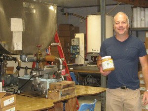 Chas Mraz poses for a photo in the honey bottling area. CVA runs two bottling lines, one for liquid honey and a second for their naturally crystallized honey.