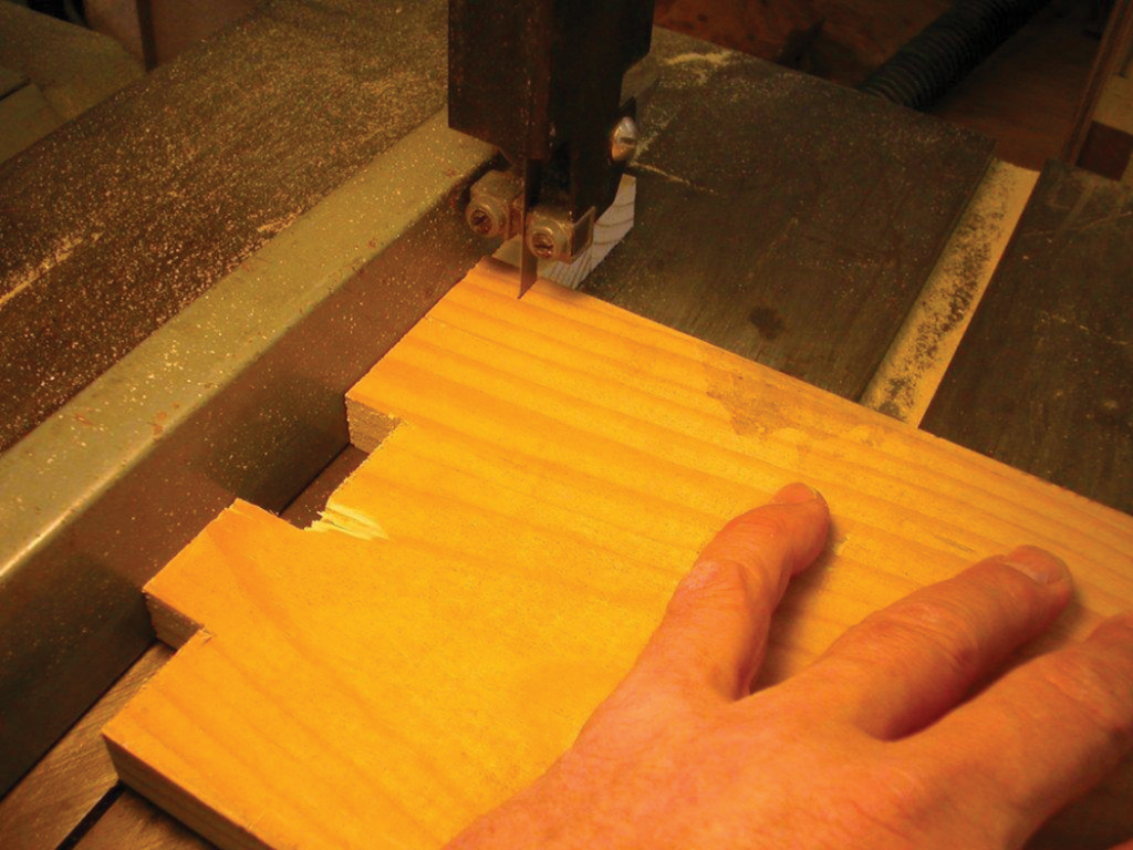 With the band saw fence set to a ¾” cut, remove the wood to reveal the fingers.