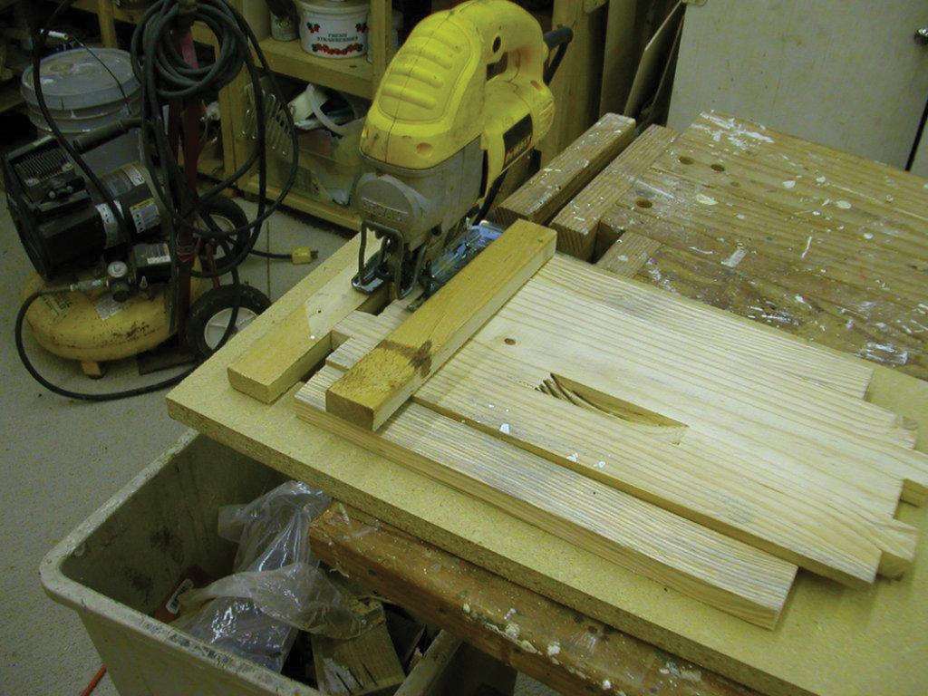 Some scrap pieces are easily assembled into a hold down, guide and stop. Note the hand holds chewed out with the dado set which lead to the router and template method of cutting hand holds.