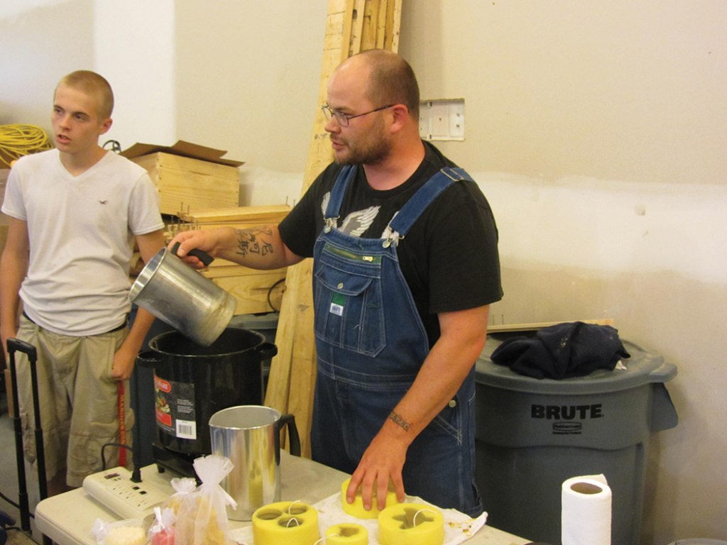 Veteran Nick and son demonstrating candle making during one of the Geezers Ridge Farm training sessions.