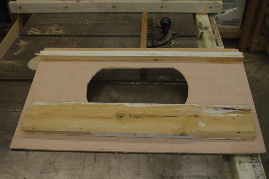 Photo shows the bottom of the template used to create handholds on the super sides. Place template over side, center, clamp to work place and route away.