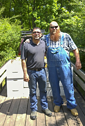 ARS Bee Research Lab insect physiologist Miguel Corona (left) and Geezer Ridge Farm beekeeper Ed Forney, (A Bee Culture contributor) in the midst of swapping of boxes of honey bees in a new partnership aimed at improving colony losses. Photo by Jay Evans, ARS Bee Research Lab.