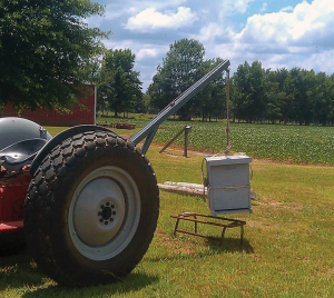 Hydraulic lift being used to pick up a hive. (photo credit – Red Belly Farm, Mississippi)