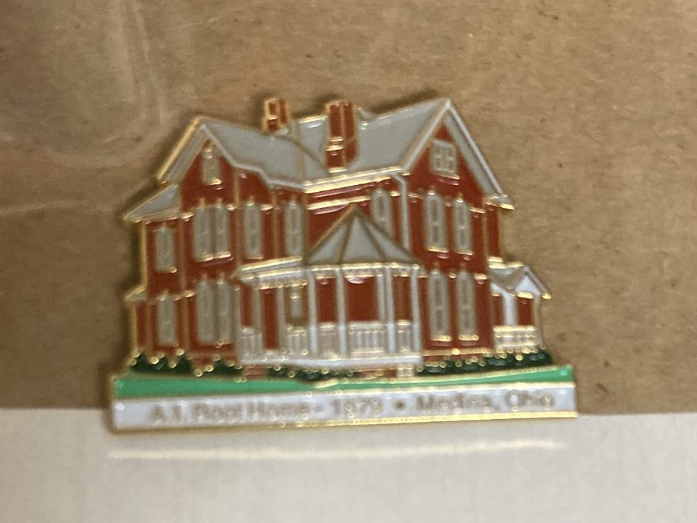 A lapel pin of the A.I. Root Homestead which still stands next to the candle store in Medina, Ohio.
